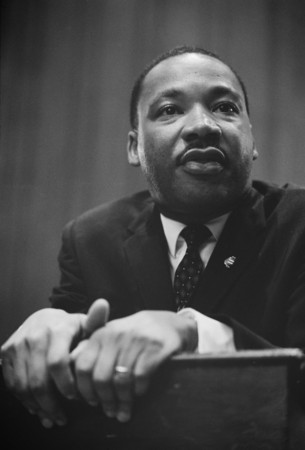 Marion S. Trikosko photograph of Martin Luther King leaning on a lectern at a press conference, March 26th 1964.